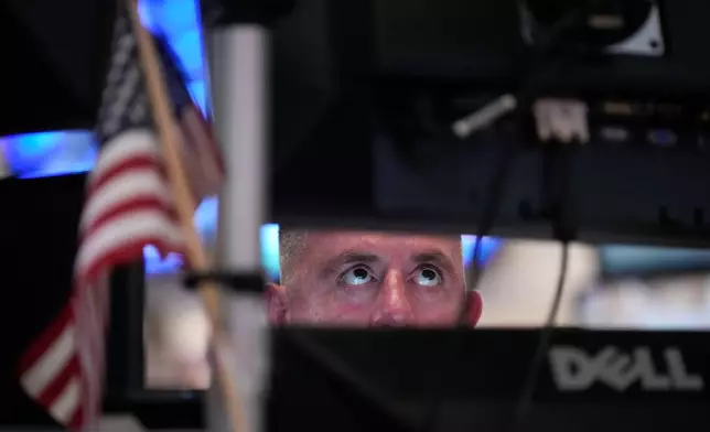 A trader works on the floor of the New York Stock Exchange, Thursday, July 30, 2026, in New York. (AP Photo/Yuki Iwamura)