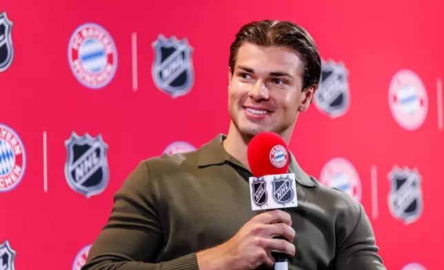 Boston Bruins’ John-Jason Peterka, speaks during a joint press conference by FC Bayern Munich and the National Hockey League, Thursday, Aug. 20, 2026, in Munich. (Matthias Balk/dpa via AP)