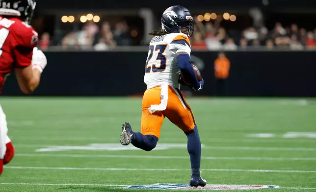 Denver Broncos cornerback Jahdae Barron (23) returns an interception for a touchdown during the first half of a preseason NFL football game, Friday, Aug. 14, 2026, in Atlanta. (AP Photo/Erik Lesser)