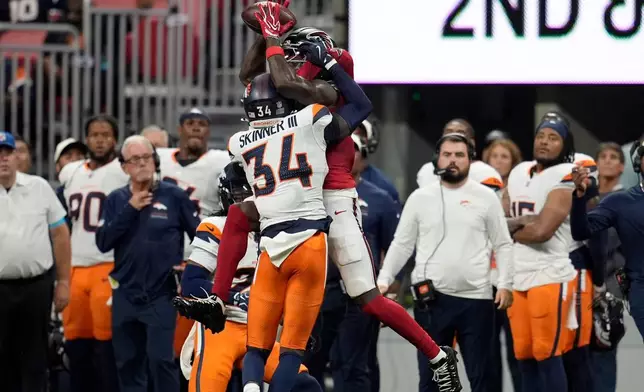 Atlanta Falcons wide receiver Chris Blair (19) makes a catch against Denver Broncos safety Jl Skinner (34) during the first half of a preseason NFL football game, Friday, Aug. 14, 2026, in Atlanta. (AP Photo/Mike Stewart)