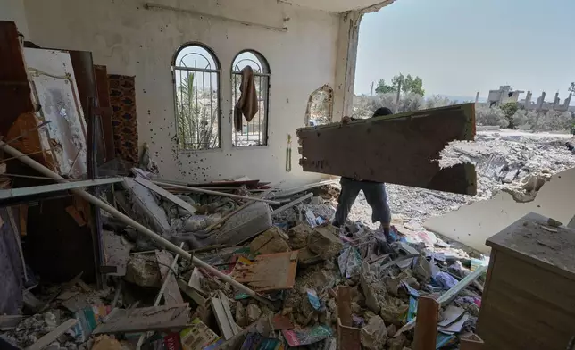 A Lebanese man removes debris from his destroyed house in the village of Zawtar al-Gharbieh, south Lebanon, Wednesday, Aug. 5, 2026. (AP Photo/Mohammed Zaatari)