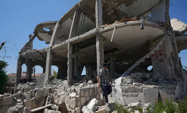 A Lebanese man checks a destroyed house in the village of Zawtar al-Gharbieh, south Lebanon, Wednesday, Aug. 5, 2026. (AP Photo/Mohammed Zaatari)