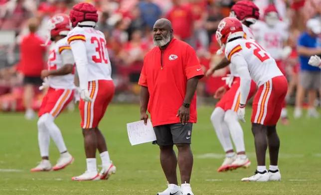 Kansas City Chiefs offensive coordinator Eric Bieniemy watches NFL football training camp Tuesday, Aug. 11, 2026, in St. Joseph, Mo. (AP Photo/Charlie Riedel)