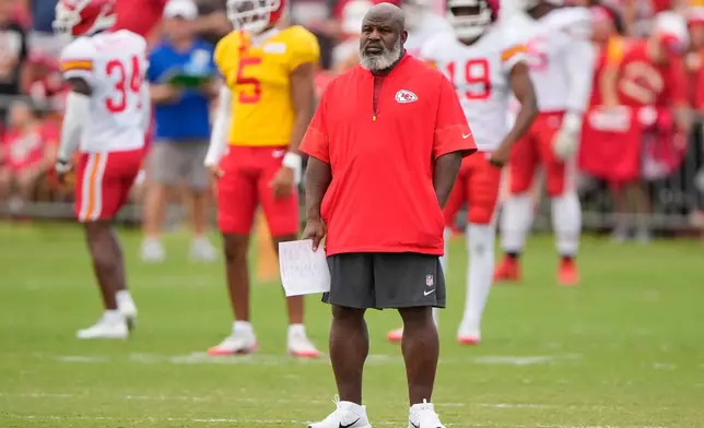 Kansas City Chiefs offensive coordinator Eric Bieniemy watches NFL football training camp Tuesday, Aug. 11, 2026, in St. Joseph, Mo. (AP Photo/Charlie Riedel)