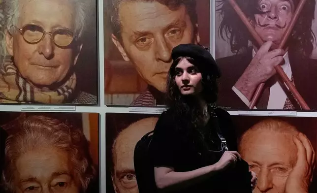 A woman visits a photography exhibition showcasing works by world photographers from the collection of the Tehran Museum of Contemporary Art, in Tehran, Iran, Saturday, Aug. 22, 2026. (AP Photo/Vahid Salemi)