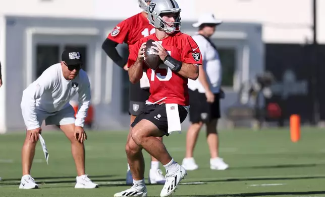 Las Vegas Raiders quarterback Fernando Mendoza (15) looks to pass during practice at the team's NFL football training camp, Thursday, July 30, 2026, in Henderson, Nev. (AP Photo/Ian Maule)