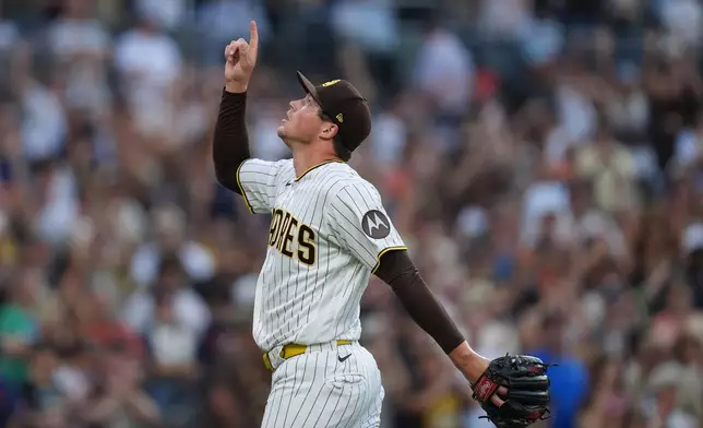 San Diego Padres pitcher Mason Miller celebrates after the Padres defeated the Houston Astros 3-2 in a baseball game Saturday, Aug. 8, 2026, in San Diego. (AP Photo/Gregory Bull)