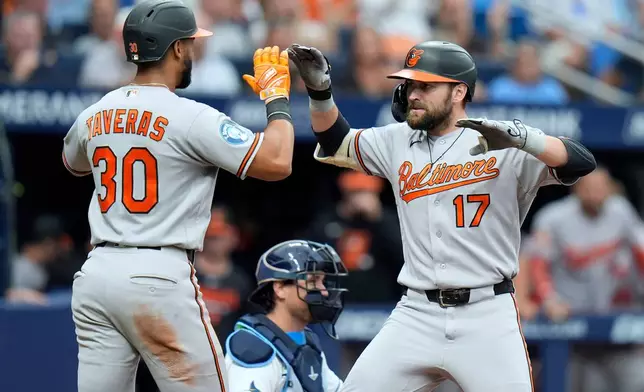 Baltimore Orioles' Colton Cowser (17) celebrates his two-run home run off Tampa Bay Rays pitcher Steven Matz with Leody Taveras (30) during the sixth inning of a baseball game Sunday, Aug. 16, 2026, in St. Petersburg, Fla. (AP Photo/Chris O'Meara)