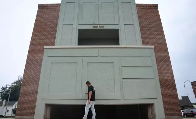Wesley Mast, owner and president of Coppes Napanee, walks past a giant replica of a Hoosier cabinet in Nappanee, Ind., Thursday, Aug. 6, 2026. (AP Photo/Obed Lamy)