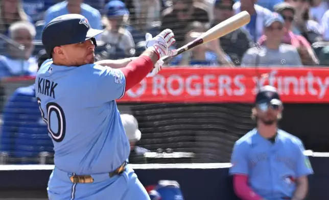 Toronto Blue Jays catcher Alejandro Kirk (30) hits an RBI single against the New York Yankees during the third inning of a baseball game in Toronto, Saturday, Aug. 15, 2026. (Jon Blacker/The Canadian Press via AP)