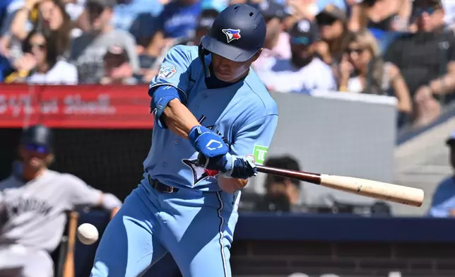 Toronto Blue Jays' Brett Bateman (21) hits a single against the New York Yankees during the first inning of a baseball game in Toronto, Saturday, Aug. 15, 2026. (Jon Blacker/The Canadian Press via AP)