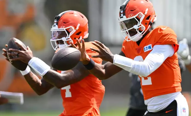 Cleveland Browns quarterbacks Deshaun Watson, left, and Shedeur Sanders participate in throwing drills during a joint NFL football practice with the Buffalo Bills in Berea, Ohio, Thursday, Aug. 20, 2026. (AP Photo/David Richard)