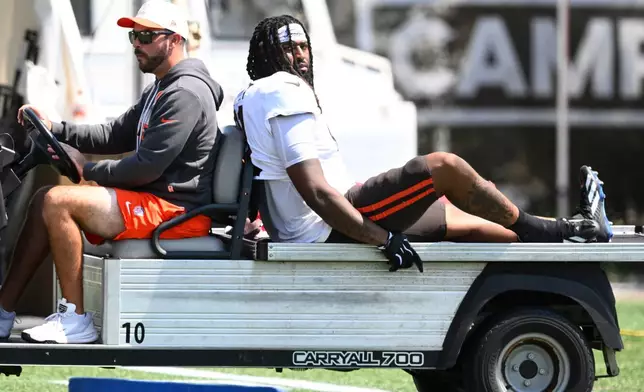 Cleveland Browns defensive end Alex Wright, right, is carted off the field with an apparent leg injury during a joint NFL football practice with the Buffalo Bills in Berea, Ohio, Thursday, Aug. 20, 2026. (AP Photo/David Richard)