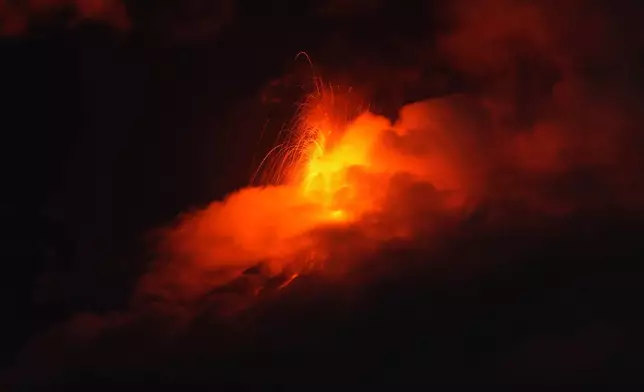 Lava flows out of the crater of the Fuego Volcano, as seen from San Juan Alotenango, Guatemala, Tuesday, Aug. 4, 2026. (AP Photo/Moises Castillo)