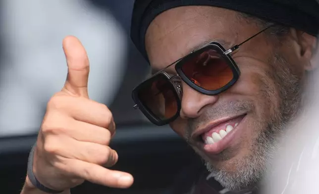 Former soccer star Ronaldinho arrives at the airport ahead the Ravenna Serie C, 2026 soccer team presentation, joining the club as a technical coach and playing in one match in Ravenna, Italy, Thursday, Aug. 20, 2026. (AP Photo/Luca Bruno)