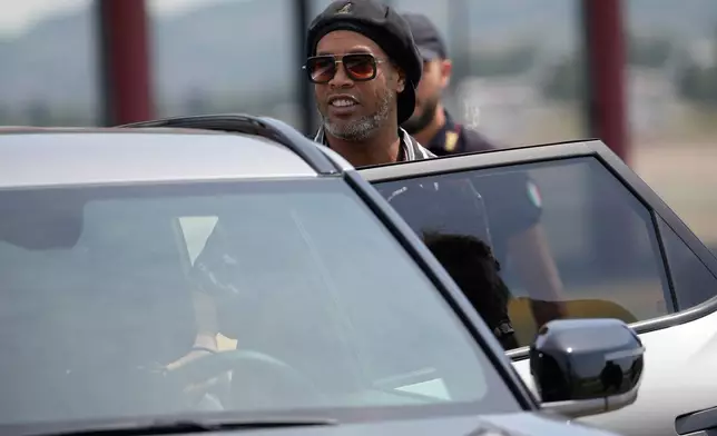 Former soccer star Ronaldinho arrives at the airport ahead the Ravenna Serie C, 2026 soccer team presentation, joining the club as a technical coach and playing in one match in Ravenna, Italy, Thursday, Aug. 20, 2026. (AP Photo/Luca Bruno)