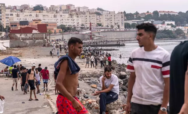 Migrants return to Morocco from the Spanish enclave of Ceuta, Friday, July 31, 2026. (AP Photo/Antonio Sempere)