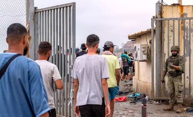Migrants return to Morocco from the Spanish enclave of Ceuta, Friday, July 31, 2026. (AP Photo/Antonio Sempere)