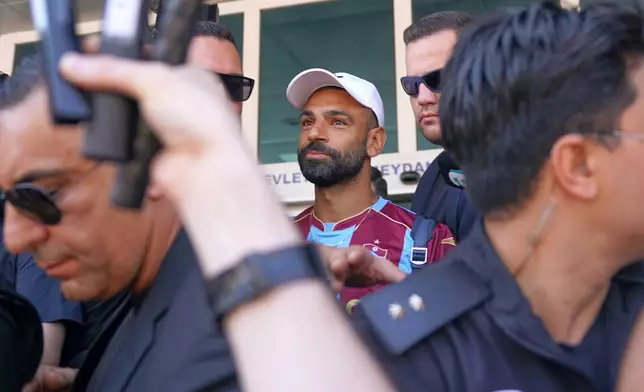 Egypt's Mohamed Salah wearing his new Trabzonspor team jersey gestures to supporters as he arrives at the airport in Istanbul, Turkey, Wednesday, Aug. 5, 2026. (Samet Yalcin/DIA Photo via AP)