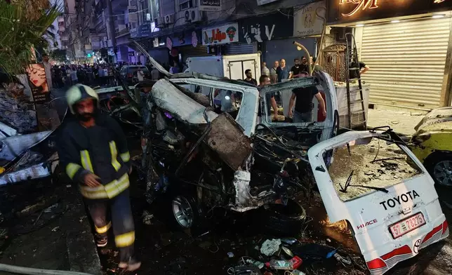 Syrian firefighters and first responders inspect damaged vehicles at the site of an explosion in the Jaramana suburb of Damascus, Syria, Thursday, Aug. 6, 2026. (AP Photo/Abdulrahman Shaheen)