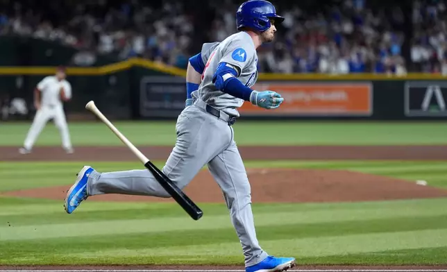 Chicago Cubs' Ian Happ flips his bat after hitting a three-run home run against the Arizona Diamondbacks during the fourth inning of a baseball game, Tuesday, Aug. 25, 2026, in Phoenix. (AP Photo/Ross D. Franklin)