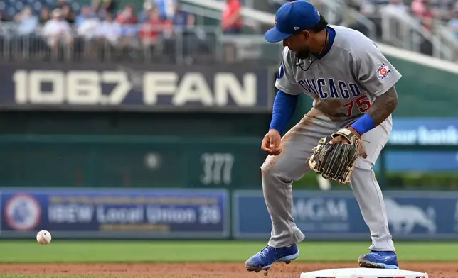 Chicago Cubs third baseman Pedro Ramírez commits a fielding error on a hit by Washington Nationals' Jacob Young during the second inning of a baseball game, Wednesday, Aug. 12, 2026, in Washington. (AP Photo/John McDonnell)