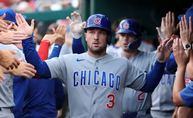 Chicago Cubs' Alex Bregman (3) is greeted in the dugout by teammates after scoring a run on a sacrifice fly hit by Nico Hoerner off of Washington Nationals pitcher Jake Irvin during the second inning of a baseball game in Washington, Tuesday, Aug 11, 2026. (AP Photo/Terrance Williams)