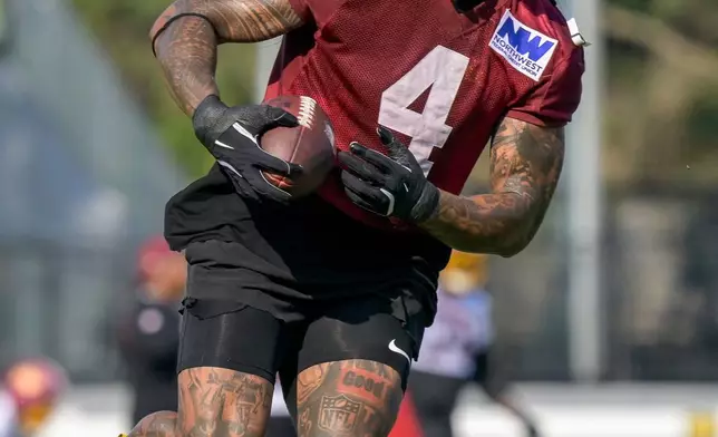 Washington Commanders linebacker Frankie Luvu (4) works out during practice at the team's NFL football training camp, Wednesday, July 29, 2026, in Ashburn, Va. (AP Photo/Rod Lamkey, Jr.)