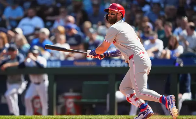 Philadelphia Phillies' Bryce Harper follows through on a double during the fifth inning of a baseball game against the Seattle Mariners, Wednesday, Aug. 26, 2026, in Seattle. (AP Photo/Lindsey Wasson)