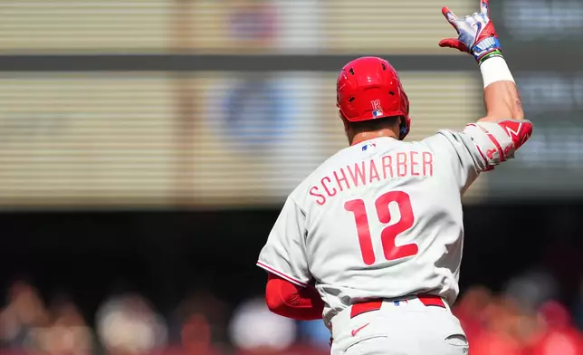 Philadelphia Phillies' Kyle Schwarber jogs the bases after hitting a three-run home run against Seattle Mariners starting pitcher Bryan Woo during the second inning of a baseball game, Wednesday, Aug. 26, 2026, in Seattle. (AP Photo/Lindsey Wasson)