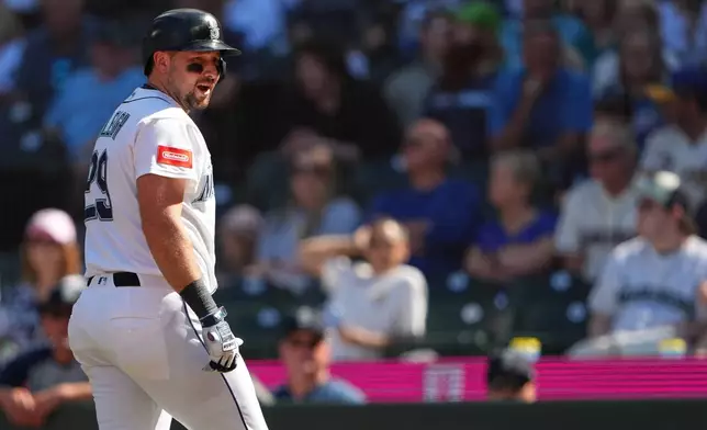 Seattle Mariners designated hitter Cal Raleigh reacts after losing a challenge and being called out on strikes during the seventh inning of a baseball game against the Philadelphia Phillies, Wednesday, Aug. 26, 2026, in Seattle. (AP Photo/Lindsey Wasson)