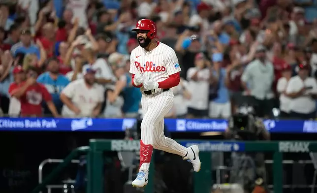 Philadelphia Phillies' Derek Hill reacts after hitting a grand slam against Washington Nationals pitcher Tom Cosgrove during the seventh inning of a baseball game Monday, Aug. 3, 2026, in Philadelphia. (AP Photo/Matt Slocum)