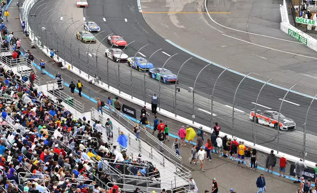 Daniel Suarez (7) makes his way through Turn 1 during a NASCAR Cup Series auto race, Sunday, Aug. 23, 2026, at New Hampshire Motor Speedway in Loudon, N.H. (AP Photo/Steven Senne)