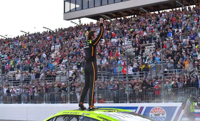 Ryan Blaney stands on his car and gestures to the crowd after winning a NASCAR Cup Series auto race, Sunday, Aug. 23, 2026, at New Hampshire Motor Speedway, in Loudon, N.H. (AP Photo/Steven Senne)