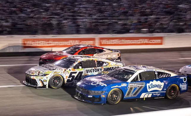 Roush Fenway Keselowski Racing driver Chris Buescher (17) and Joe Gibbs Racing driver Ty Gibbs (54) battle in turn one during Cook Out 400 at Richmond Raceway, Saturday, Aug. 15, 2026, in Richmond Va. (AP Photo/Robert Simmons)