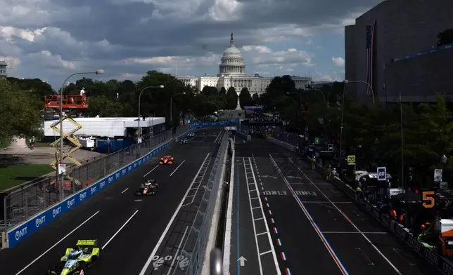 Christian Rasmussen (21), of Denmark, leads a pack of cars during the IndyCar Freedom 250 Grand Prix auto race in Washington, Sunday, Aug. 23, 2026. (AP Photo/Allison Robbert)