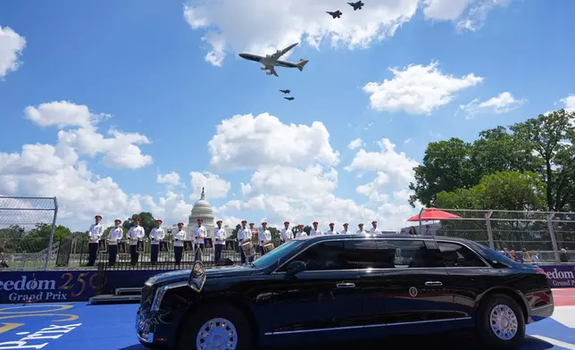 Air Force One and four F-35's pass over as President Donald Trump, in the presidential limousine known as "The Beast," does a lap around the track before the IndyCar Freedom 250 Grand Prix auto race in Washington, Sunday, Aug. 23, 2026. (AP Photo/Alex Brandon)