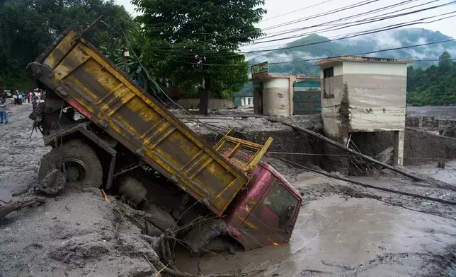 A vehicle is seen in the aftermath of a flash floods in Devighat in the Nuwakot district in Nepal. Thursday, Aug 27, 2026. (AP Photo/Niranjan Shrestha)