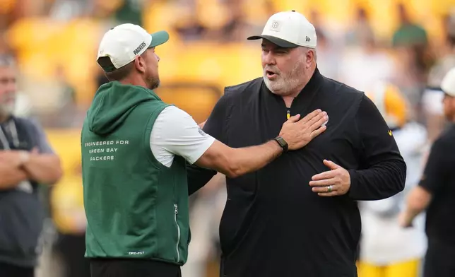 Green Bay Packers head coach Matt LaFleur, left, and Pittsburgh Steelers head coach Mike McCarthy, right, greet each other on the field before a preseason NFL football game in Pittsburgh, Thursday, Aug. 13, 2026. (AP Photo/Gene J. Puskar)