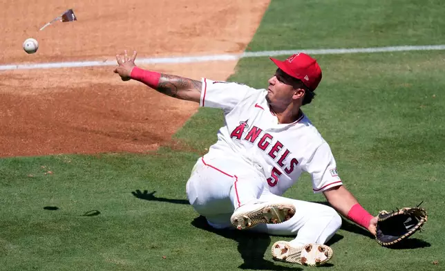Los Angeles Angels first baseman Vaughn Grissom tosses the ball, along with his sunglasses, to first as he fails to throw out Cleveland Guardians' Travis Bazzana during the third inning of a baseball game Wednesday, Aug. 26, 2026, in Anaheim, Calif. (AP Photo/Mark J. Terrill)