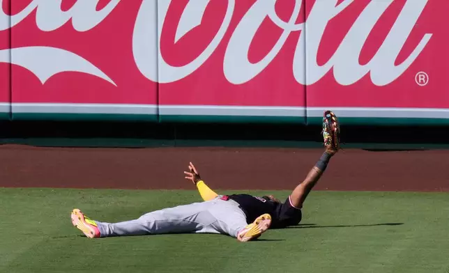 Cleveland Guardians left fielder Angel Martínez gestures after making a catch on a ball hit by Los Angeles Angels' Zach Neto during the seventh inning of a baseball game Wednesday, Aug. 26, 2026, in Anaheim, Calif. (AP Photo/Mark J. Terrill)