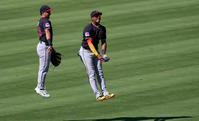 Cleveland Guardians' Steven Kwan, left, and Angel Martínez celebrate after the Guardians defeated the Los Angeles Angels in a baseball game Wednesday, Aug. 26, 2026, in Anaheim, Calif. (AP Photo/Mark J. Terrill)