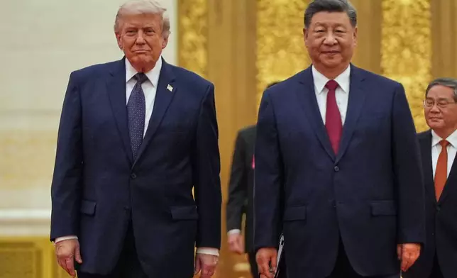 FILE - President Donald Trump, left, and Chinese President Xi Jinping arrive a state dinner at the Great Hall of the People May 14, 2026, in Beijing. (AP Photo/Mark Schiefelbein)