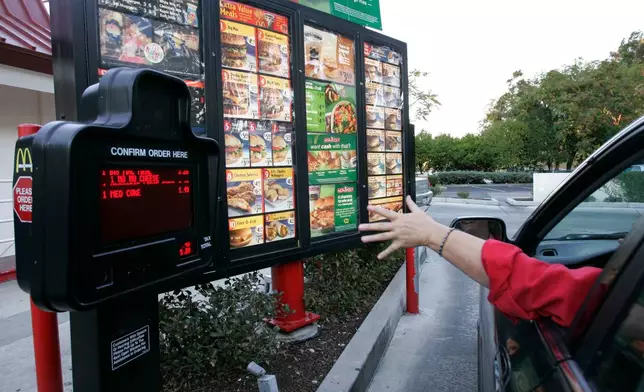 FILE - A customer orders a meal at a drive-thru at McDonald's restaurant in Palo Alto, Calif., Wednesday, Oct. 18, 2006. (AP Photo/Paul Sakuma, File)