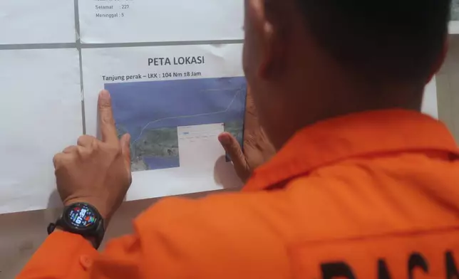 A member of Indonesia's rescue agency points a map showing the location where passenger ferry Mutiara Sentosa 2 caught fire off Madura Island, at the rescue operation's command center in Surabaya, East Java, Indonesia, Sunday, Aug. 2, 2026. (AP photo/Trisnadi)