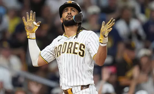 San Diego Padres' Fernando Tatis Jr. celebrates after hitting a home run during the fourth inning of a baseball game Tuesday, Aug. 11, 2026, in San Diego. (AP Photo/Gregory Bull)