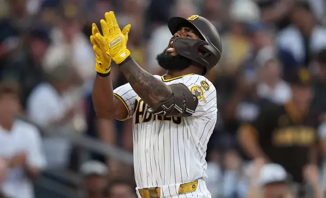 San Diego Padres' Luis Rengifo celebrates after hitting a grand slam home run during the second inning of a baseball game against the Milwaukee Brewers Tuesday, Aug. 11, 2026, in San Diego. (AP Photo/Gregory Bull)