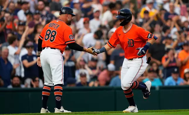 Detroit Tigers' Ben Malgeri, right, celebrates his two-run home run with third base coach Billy Boyer (88) against the Chicago White Sox during the first inning of a baseball game Friday, Aug. 14, 2026, in Detroit. (AP Photo/Paul Sancya)