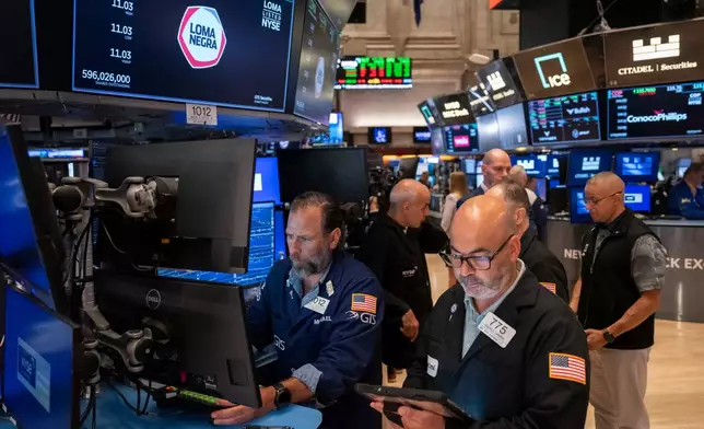 Trader Fred Demarco, right, and Specialist Michael Pistillo, left, work on the floor of the New York Stock Exchange, Friday, Aug. 7, 2026, in New York. (AP Photo/Yuki Iwamura)