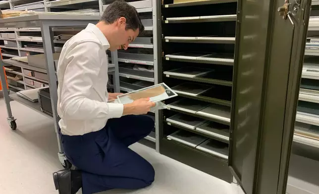 University of Michigan Papyrology Collection curator Giuliano Sidro looks at fragments of the Epistles of Paul Thursday, Aug. 6, 2026, in Ann Arbor, Mich. (AP Photo/Mike Householder)